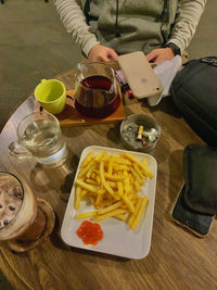 High angle view of woman holding food on table