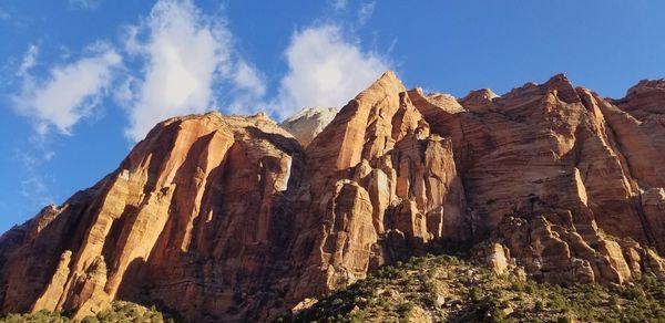 Low angle view of rock formations against sky