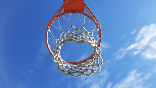 Low angle view of basketball hoop against blue sky