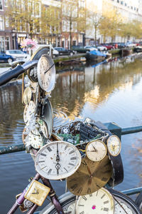 Reflection of clock on river in city