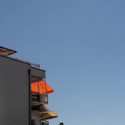 Low angle view of building against clear blue sky