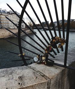 Metal bridge over river against sky