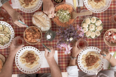 Cropped hands of people having food on table