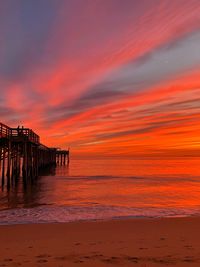 Scenic view of beach against sky during sunset