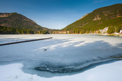 Scenic view of frozen lake against sky