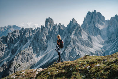 Man standing on mountain against sky