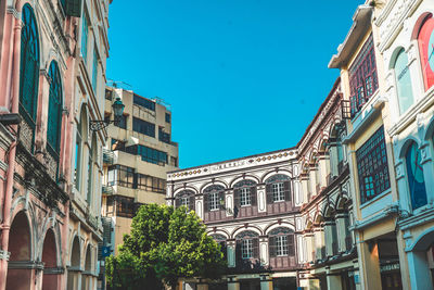 Low angle view of residential building against blue sky