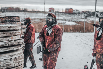 Men standing on snow during winter