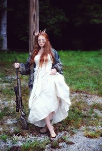 Portrait of teenage girl wearing dress standing on land