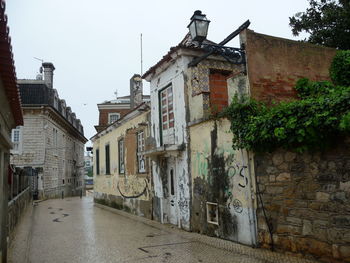 Houses by water against sky