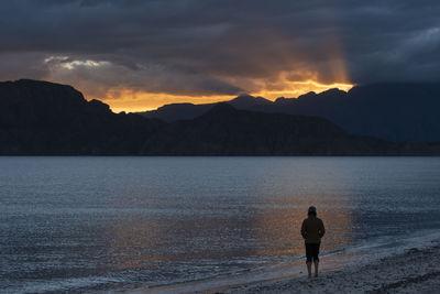 One person walking at the beach at sunset in carmen island, loreto, baja california, mexico.