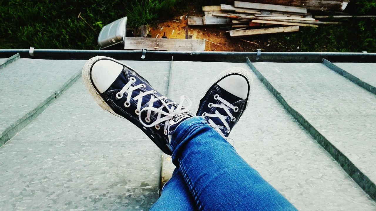 shoe, person, low section, personal perspective, footwear, high angle view, human foot, men, lifestyles, relaxation, canvas shoe, close-up, footpath, green, day, outdoors, wood paneling