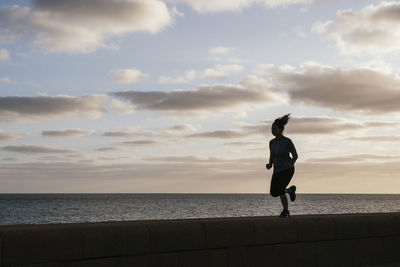 Girl running near the sea