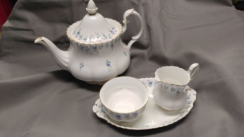 High angle view of tea pot and tea cup set on table