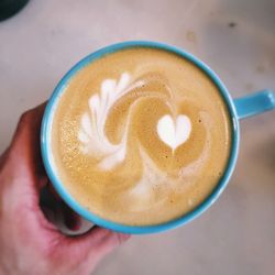 Close-up of hand holding coffee cup