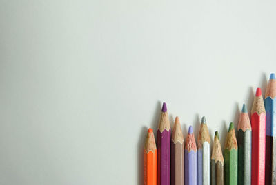 Close-up of colored pencils against white background