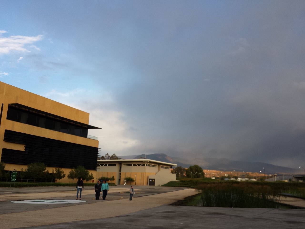 building exterior, architecture, built structure, sky, cloud - sky, city, street, walking, cloudy, residential building, residential structure, men, city life, cloud, building, road, lifestyles, outdoors, person