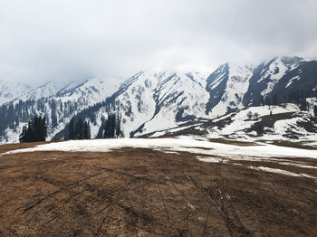 Scenic view of snowcapped mountains against sky