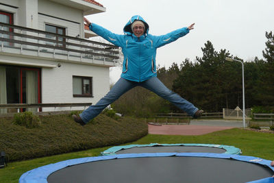 Portrait of smiling mature man jumping on trampoline