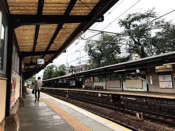 Train at railroad station against sky