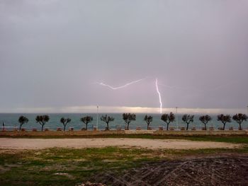 Panoramic view of people on land against sky