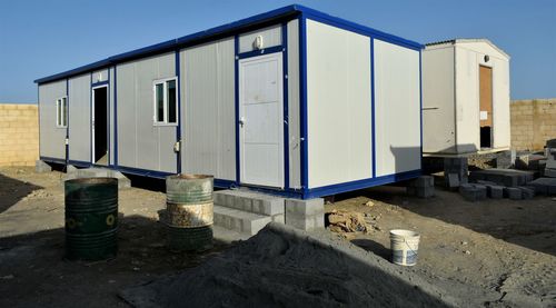 Exterior of abandoned building against clear blue sky