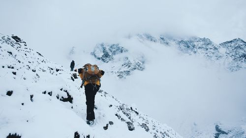 Woman standing on snow covered mountain