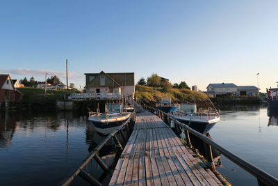 Scenic view of boats near jetty against clear sky