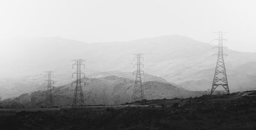 Scenic view of powerlines in a mountain