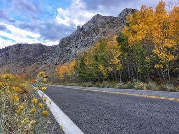 Surface level of empty road against rocky mountains