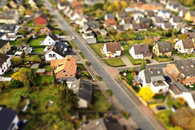 High angle view of street amidst houses in city