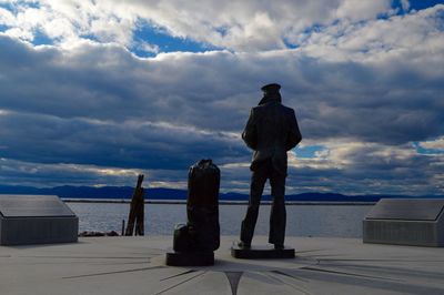 Man standing by sea against sky