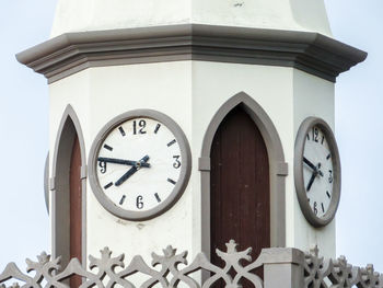 Low angle view of clock on building wall