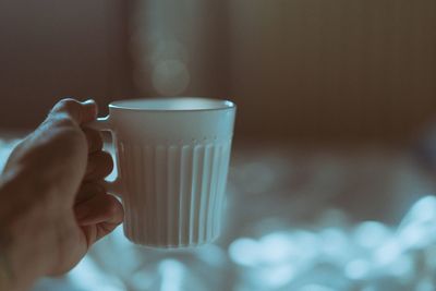 Close-up of hand holding coffee cup