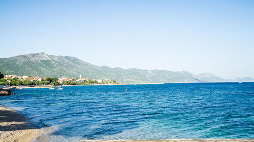 Scenic view of sea against clear blue sky