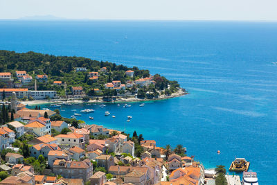 High angle view of town by sea against clear sky