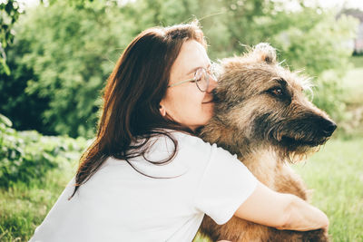 Young woman with dog on field