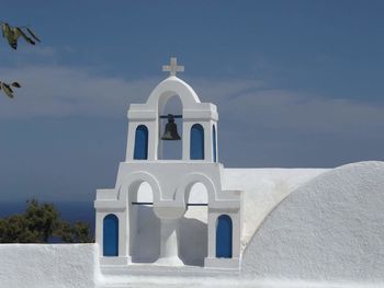 View of white cathedral against cloudy sky