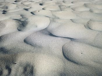 High angle view of footprints on sand at beach