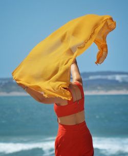 Woman standing with yellow shawl