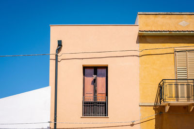 Low angle view of building against clear blue sky