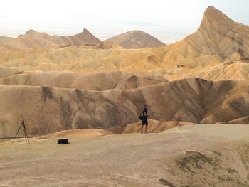 Rear view of man standing on rock formations