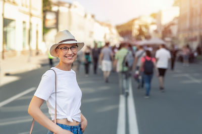 Smiling woman standing on street in city