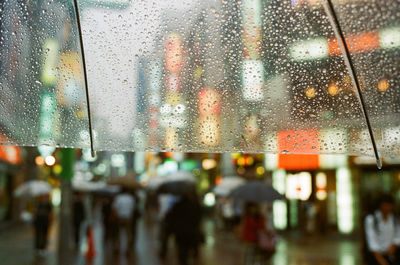 Cropped umbrella with raindrops at night