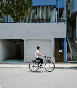 Man riding bicycle on street in city