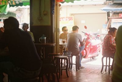 Rear view of people sitting at restaurant