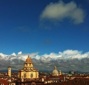 Buildings against cloudy sky