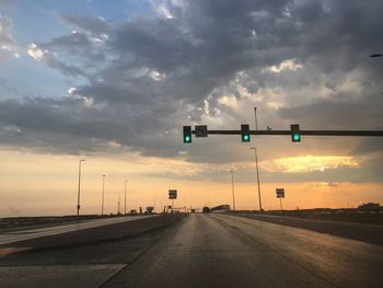 Road sign against sky during sunset