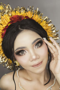 Close-up portrait of young woman with balinese traditional wedding