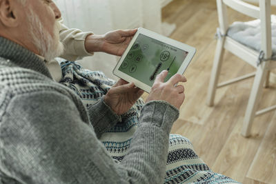 Man adjusting temperature on smart home device